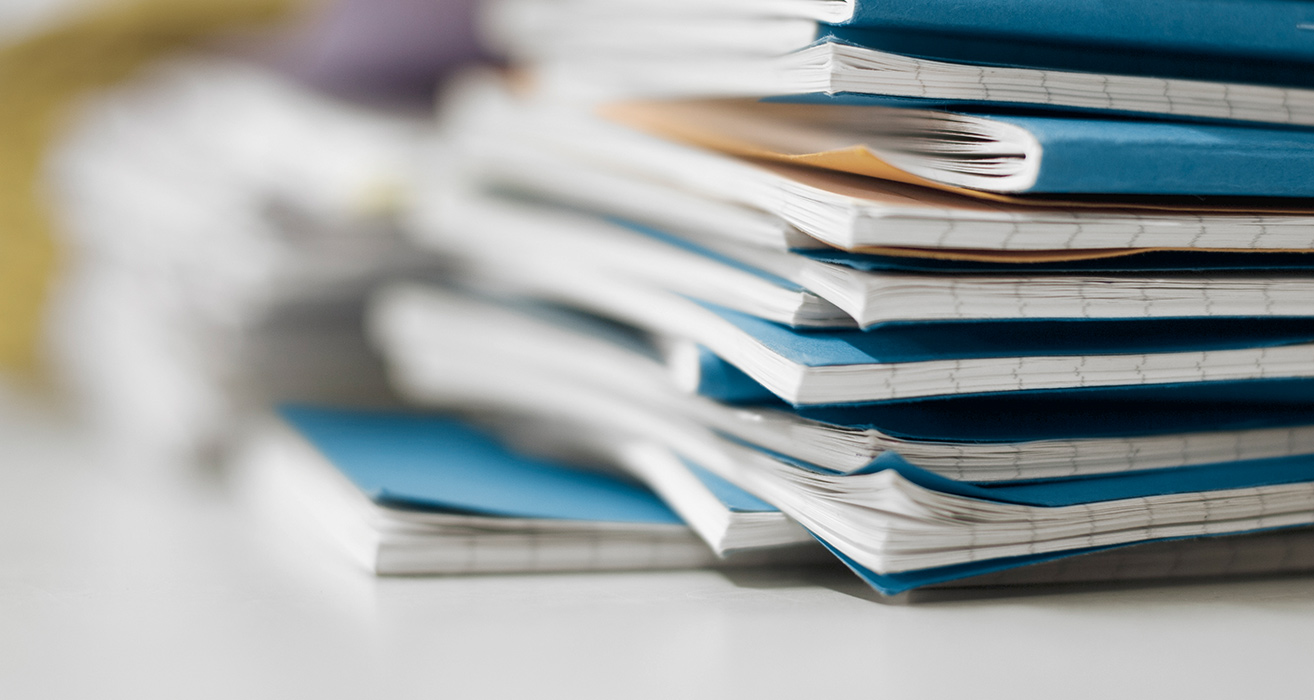A stack of exercise books. 