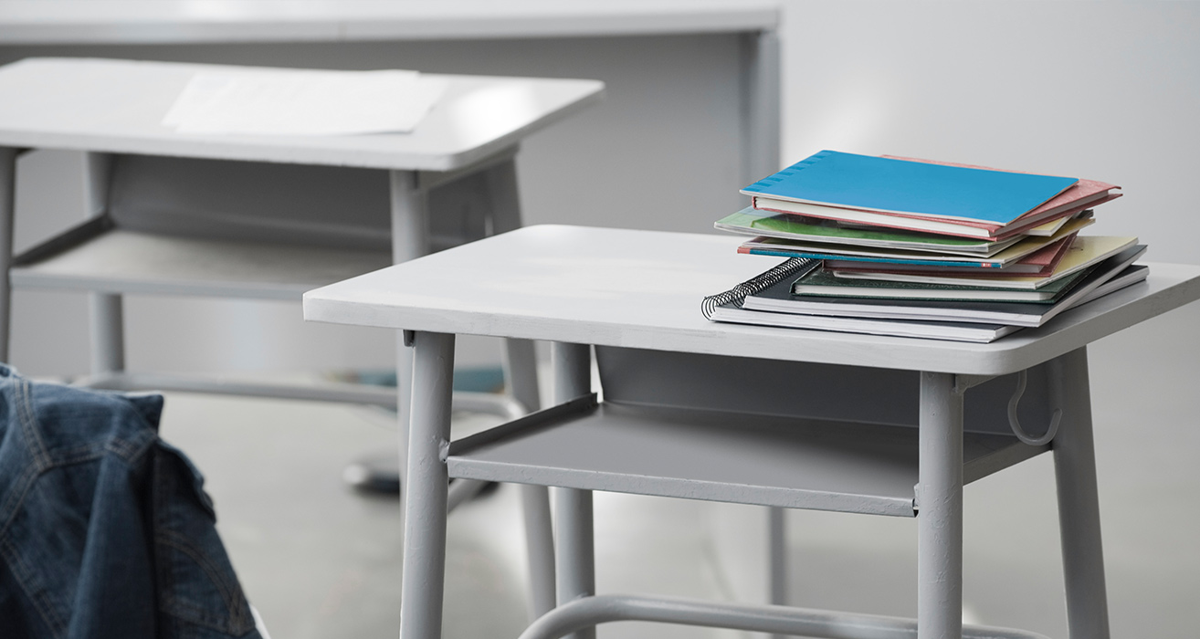 A stack of exercise books. 
